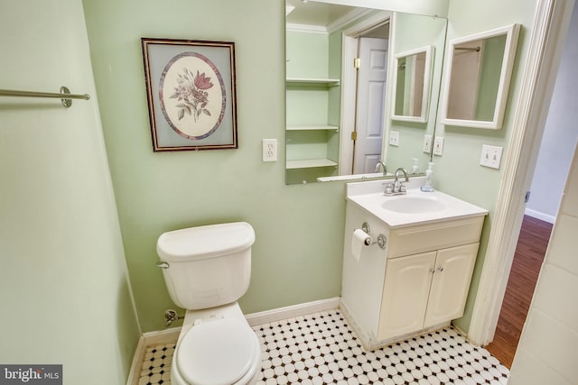 bathroom featuring crown molding, tile flooring, toilet, and vanity