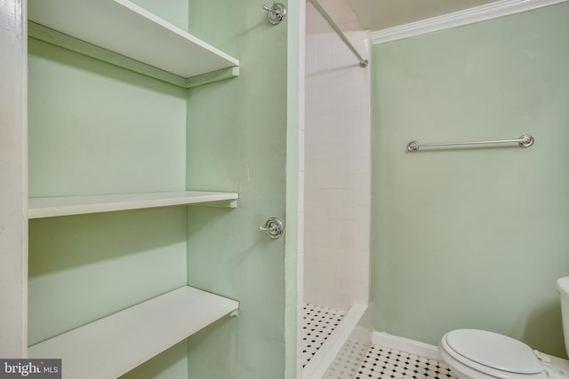 bathroom with walk in shower, toilet, and tile floors