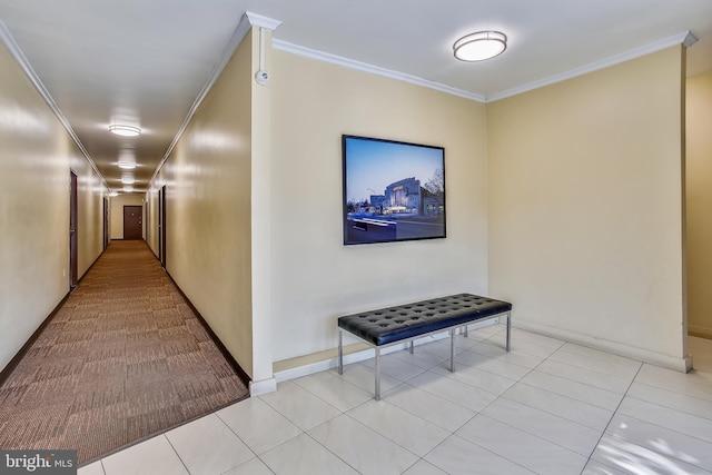 hall with crown molding and light tile flooring