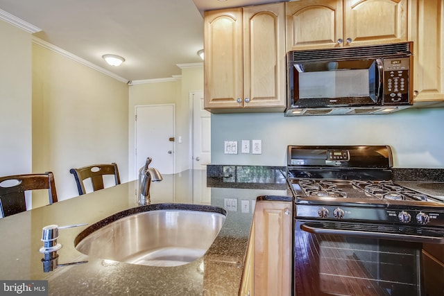 kitchen with light brown cabinetry, ornamental molding, a breakfast bar area, black appliances, and sink