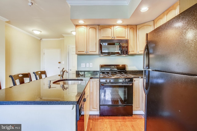 kitchen with light brown cabinetry, light wood-type flooring, sink, crown molding, and black appliances