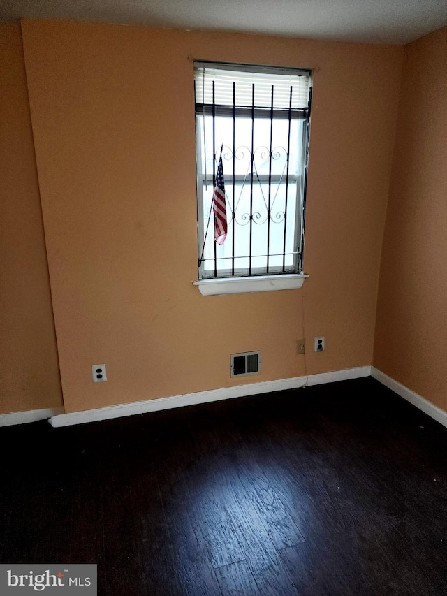 spare room featuring dark hardwood / wood-style flooring