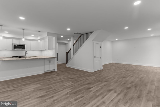 2764 Bellview Dr, Bensalem, PA 19020 - kitchen featuring stainless steel microwave, open floor plan, white cabinetry, light wood-type flooring, and recessed lighting