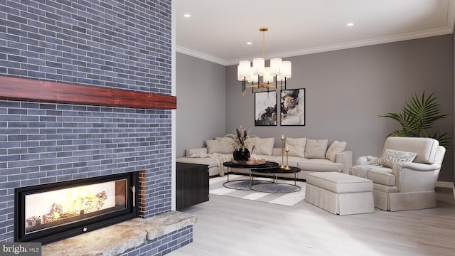 living room featuring crown molding, light hardwood / wood-style flooring, and an inviting chandelier