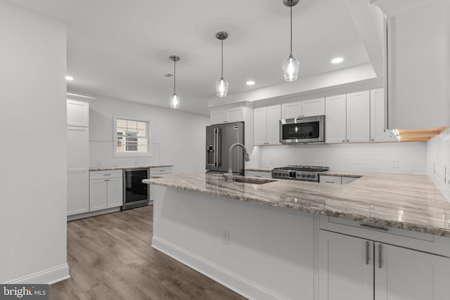 2764 Bellview Dr, Bensalem, PA 19020 - kitchen featuring appliances with stainless steel finishes, wine cooler, a sink, a peninsula, and backsplash