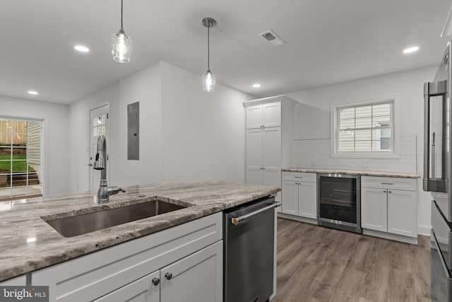 2764 Bellview Dr, Bensalem, PA 19020 - kitchen with beverage cooler, a sink, stainless steel appliances, white cabinetry, and hanging light fixtures