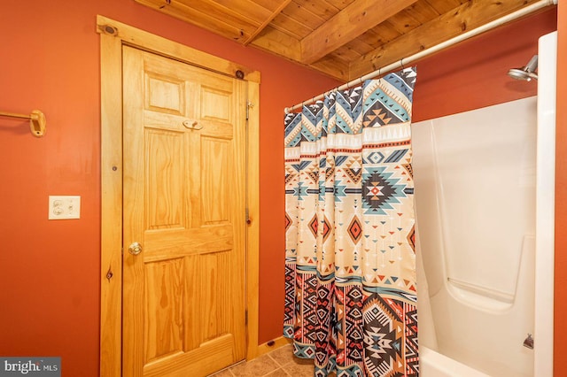 bathroom with wooden ceiling, shower / tub combo with curtain, and tile floors