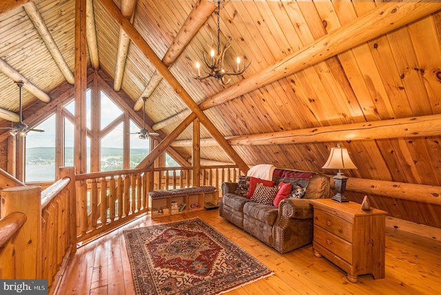 living room with wooden ceiling, a chandelier, vaulted ceiling with beams, and light hardwood / wood-style flooring