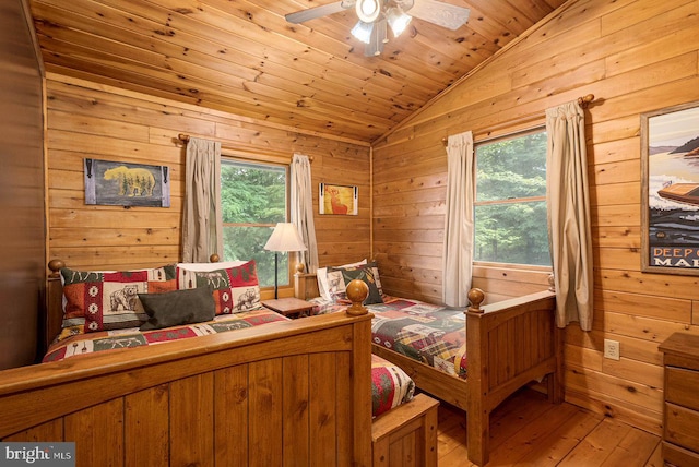 bedroom with hardwood / wood-style flooring, lofted ceiling, wood ceiling, and multiple windows