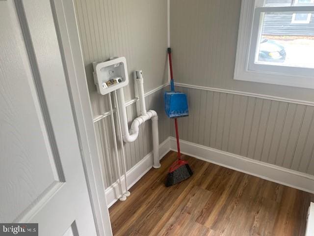 clothes washing area featuring dark hardwood / wood-style flooring and hookup for a washing machine