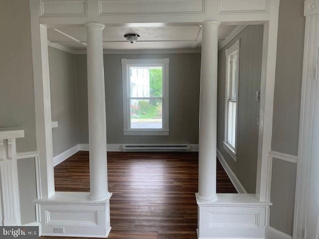 unfurnished room with ornate columns, a baseboard radiator, and dark wood-type flooring