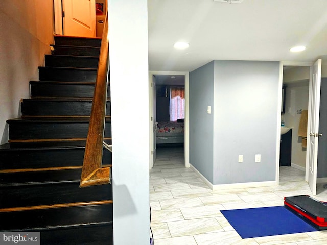 staircase featuring light tile floors