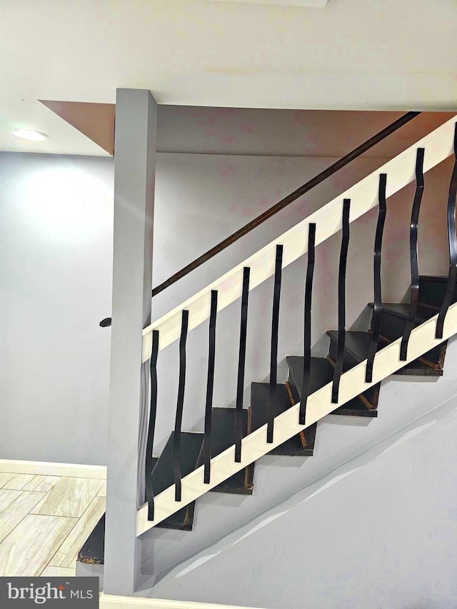 stairway featuring light hardwood / wood-style floors