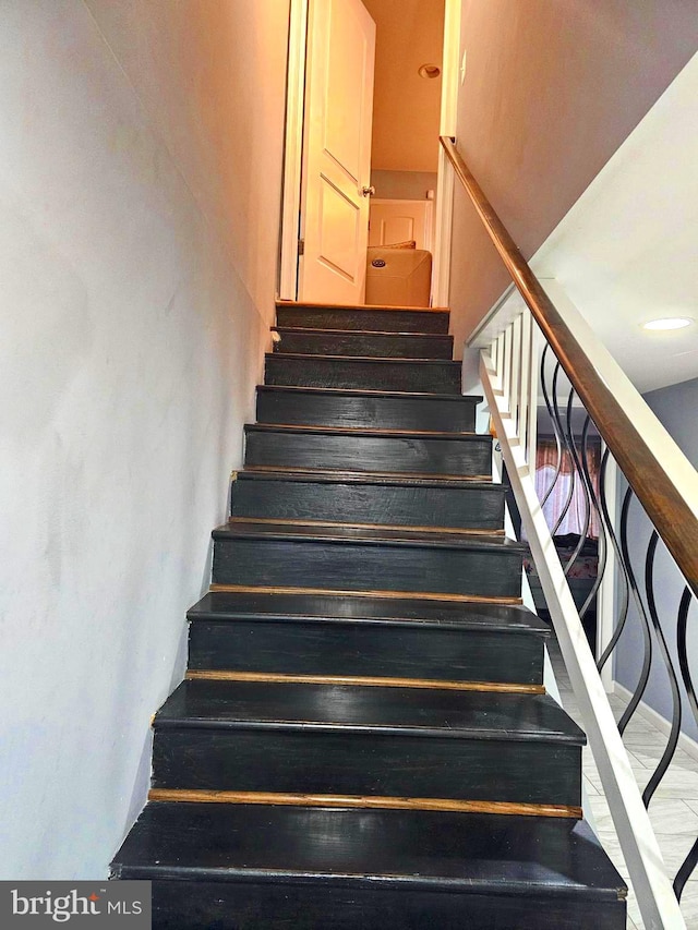 stairs featuring wood-type flooring