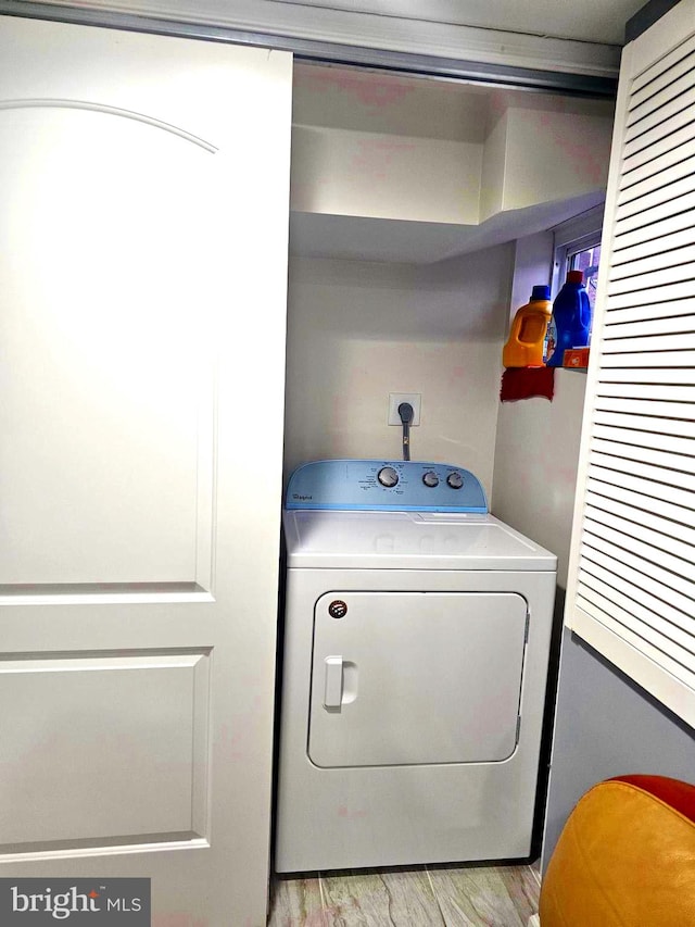 washroom with washer / dryer and light wood-type flooring