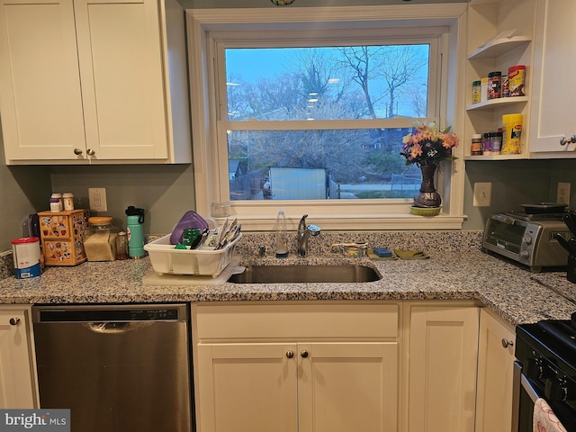 kitchen featuring stainless steel dishwasher, range with electric cooktop, sink, light stone countertops, and white cabinets