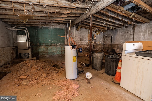 basement featuring water heater and washer / dryer