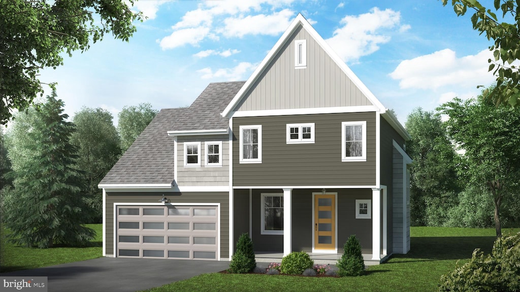 view of front of home with covered porch, a front yard, and a garage