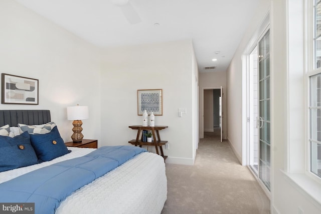 bedroom featuring ceiling fan and light carpet