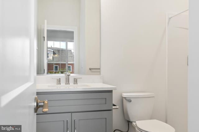 bathroom featuring vanity and toilet