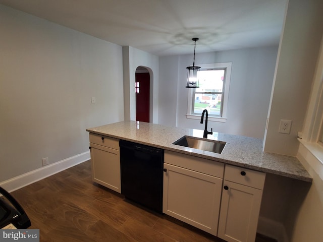 kitchen featuring dark hardwood / wood-style floors, sink, light stone counters, dishwasher, and pendant lighting