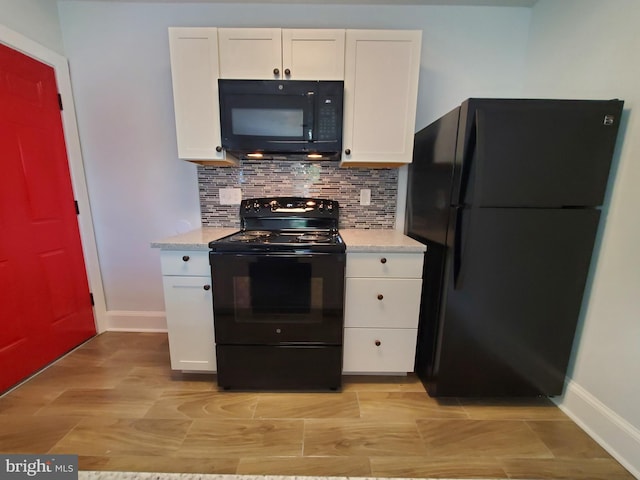 kitchen featuring backsplash, light stone counters, black appliances, and white cabinets