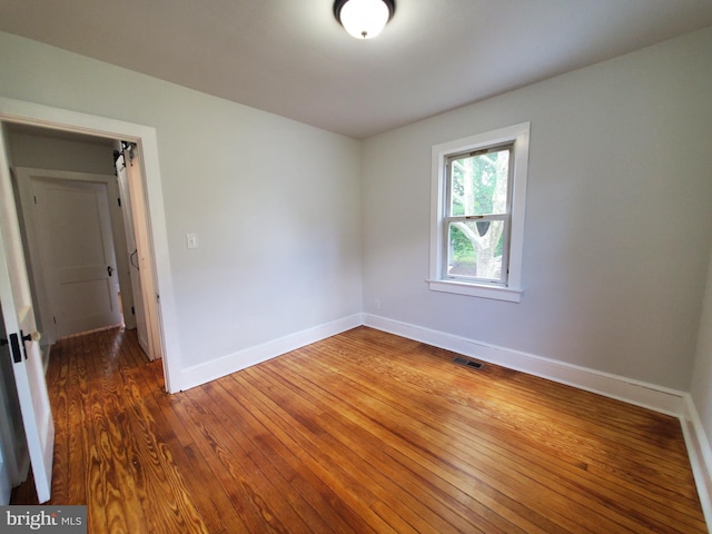 unfurnished room featuring dark hardwood / wood-style floors