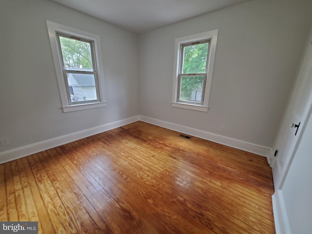 spare room featuring light hardwood / wood-style floors