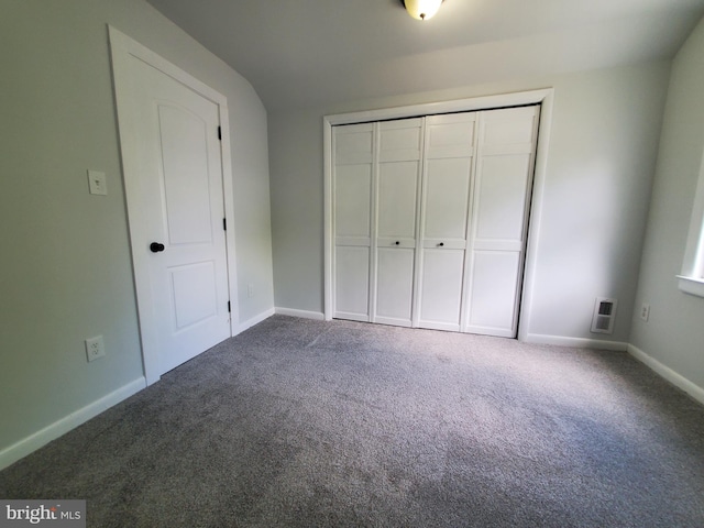 unfurnished bedroom featuring carpet floors and a closet