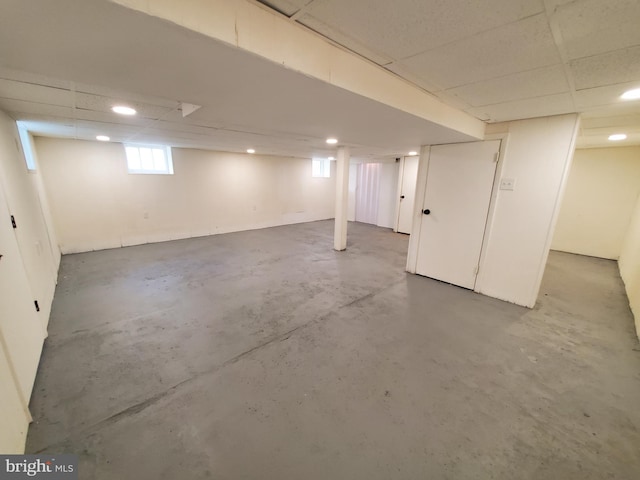 basement with a paneled ceiling