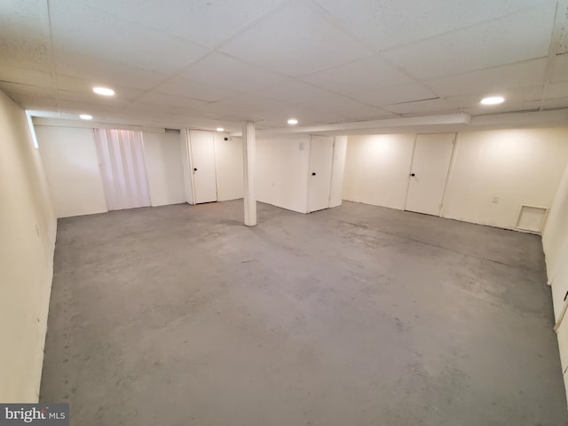 basement with a paneled ceiling