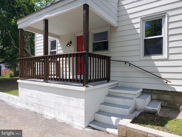 view of exterior entry with a porch