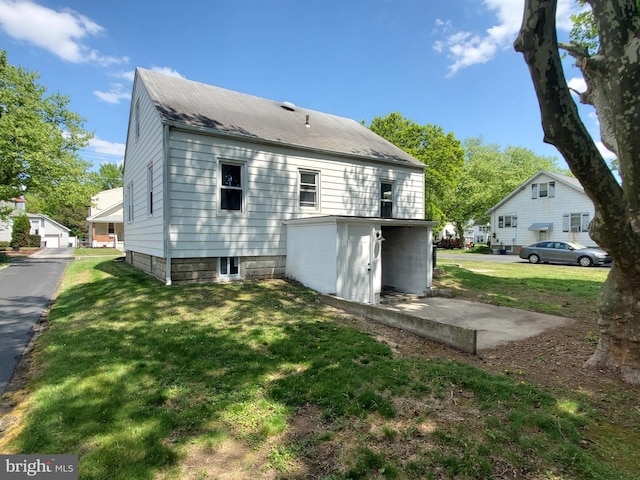 rear view of house featuring a lawn