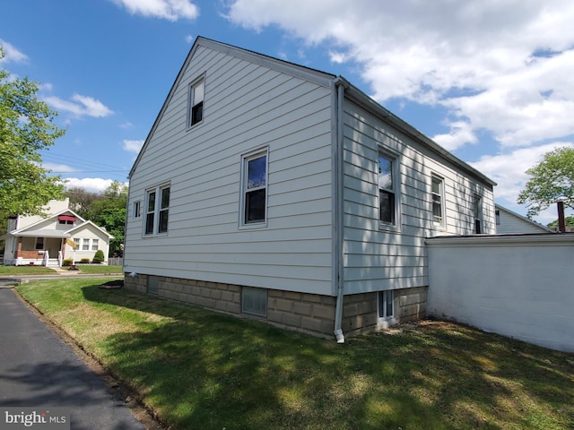 view of side of property with a yard