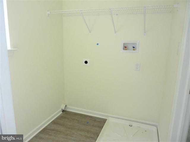 washroom featuring electric dryer hookup, light hardwood / wood-style floors, and hookup for a washing machine