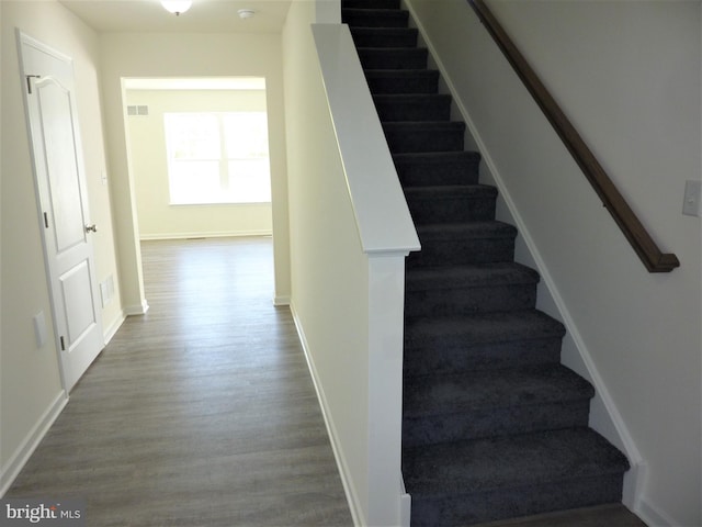 stairs with hardwood / wood-style floors