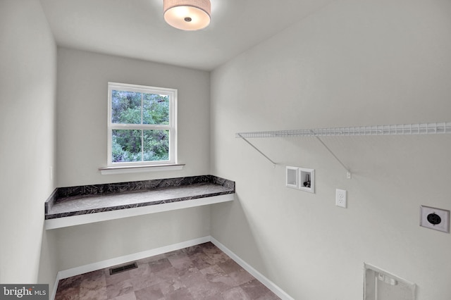 clothes washing area with electric dryer hookup, washer hookup, and light tile flooring