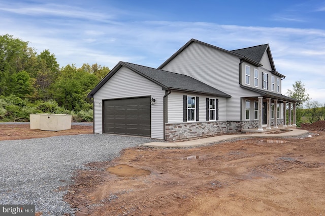 view of front of home featuring a porch and a garage