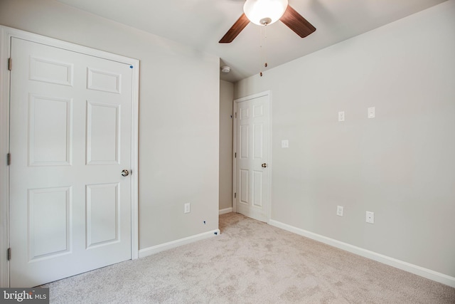 unfurnished bedroom featuring light carpet and ceiling fan