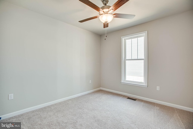 carpeted spare room with ceiling fan