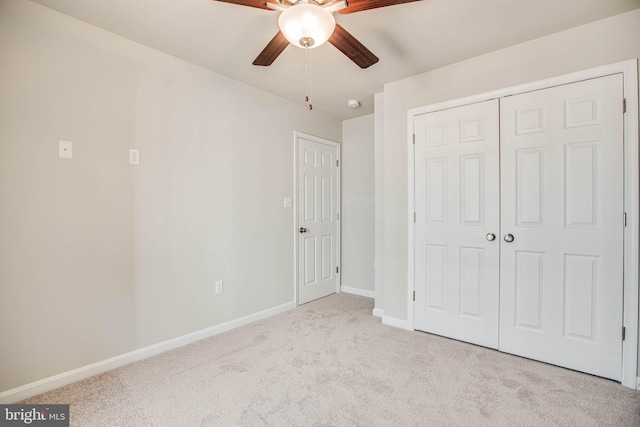 unfurnished bedroom featuring a closet, ceiling fan, and light carpet