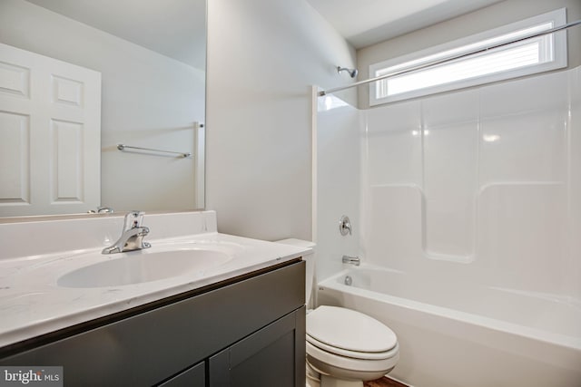 full bathroom featuring  shower combination, vanity, and toilet