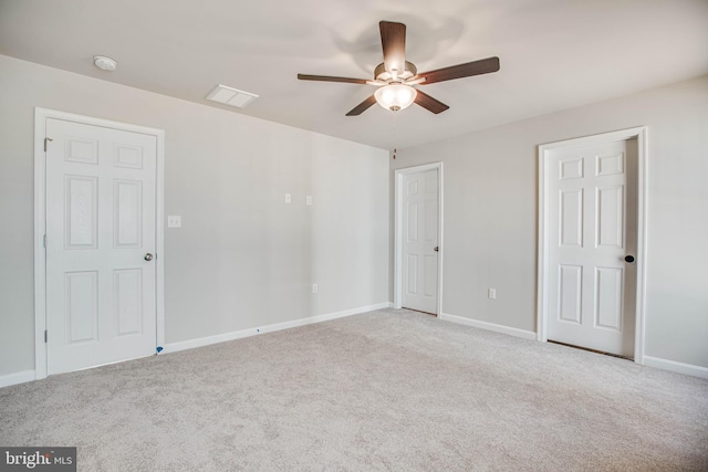 spare room with ceiling fan and light carpet