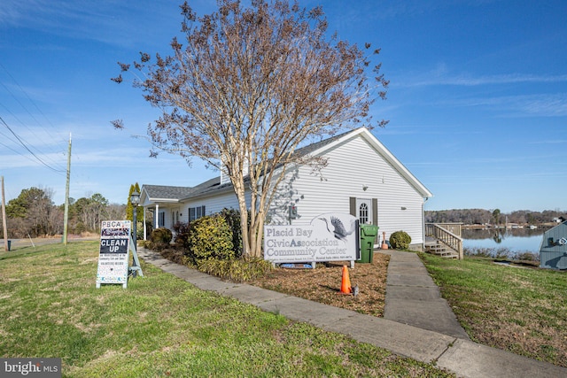 view of side of home with a lawn