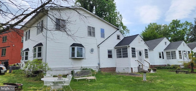 rear view of property featuring a yard