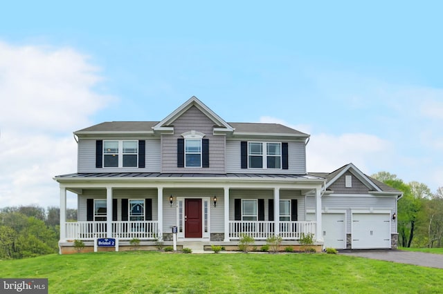 view of front facade featuring a garage, a front yard, and a porch