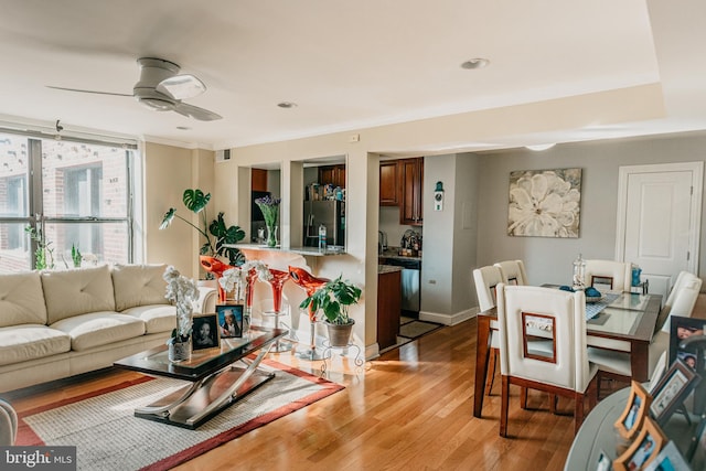 living room featuring light hardwood / wood-style floors and ceiling fan