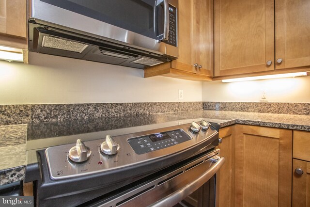 kitchen featuring brown cabinets and appliances with stainless steel finishes