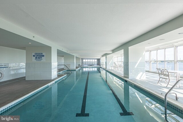 view of swimming pool featuring a water view