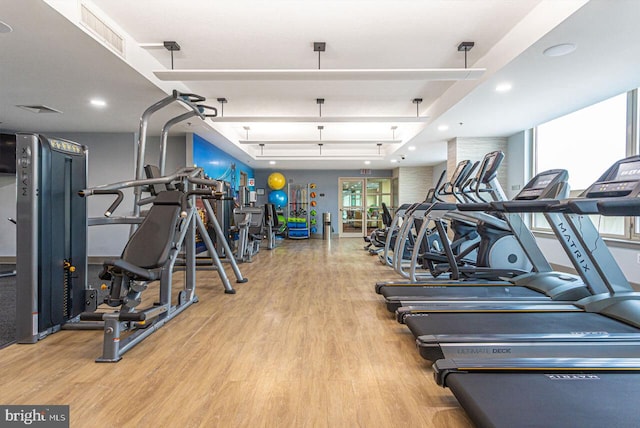 exercise room with visible vents, recessed lighting, and wood finished floors